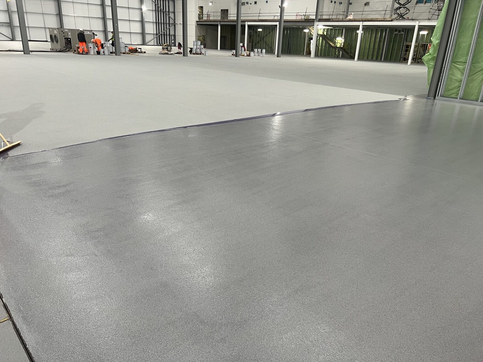 Large completed grey resin floor in an industrial building